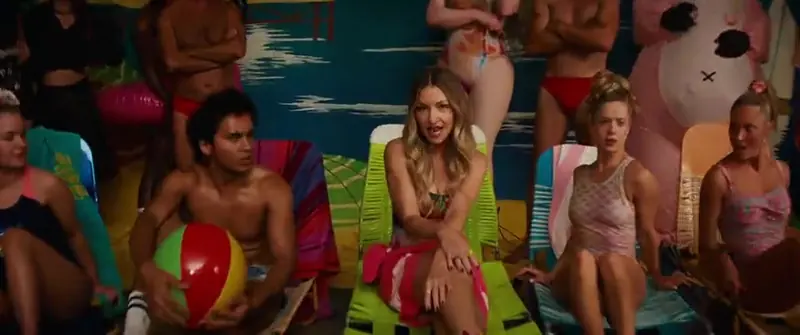 Holiday: a group lounges on deckchairs with beach balls and inflatables in front of a painted ocean