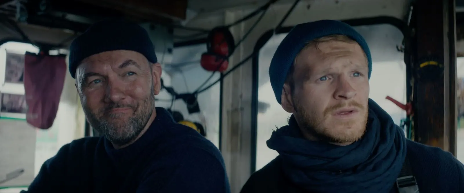 Never Never Never: two fishermen in beanies inside a boat’s wheelhouse