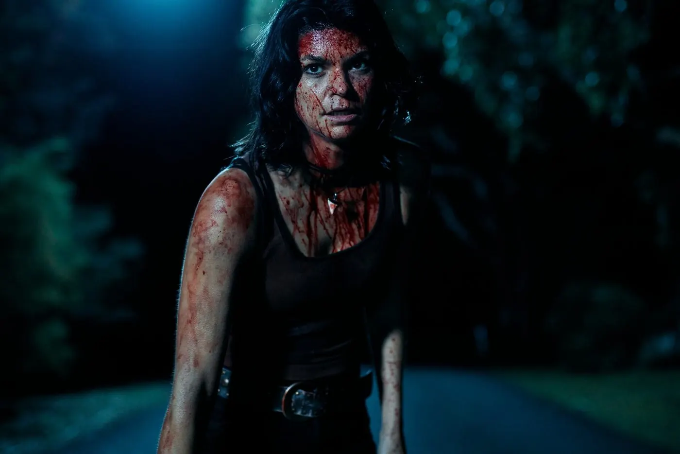 Penny Lane Is Dead: a dark-haired young woman covered in blood stands on a road at night